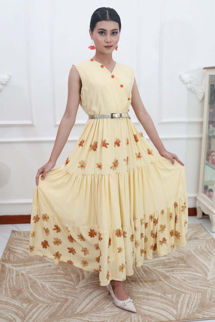 Pale yellow tiered eco-print dress with a floral hem