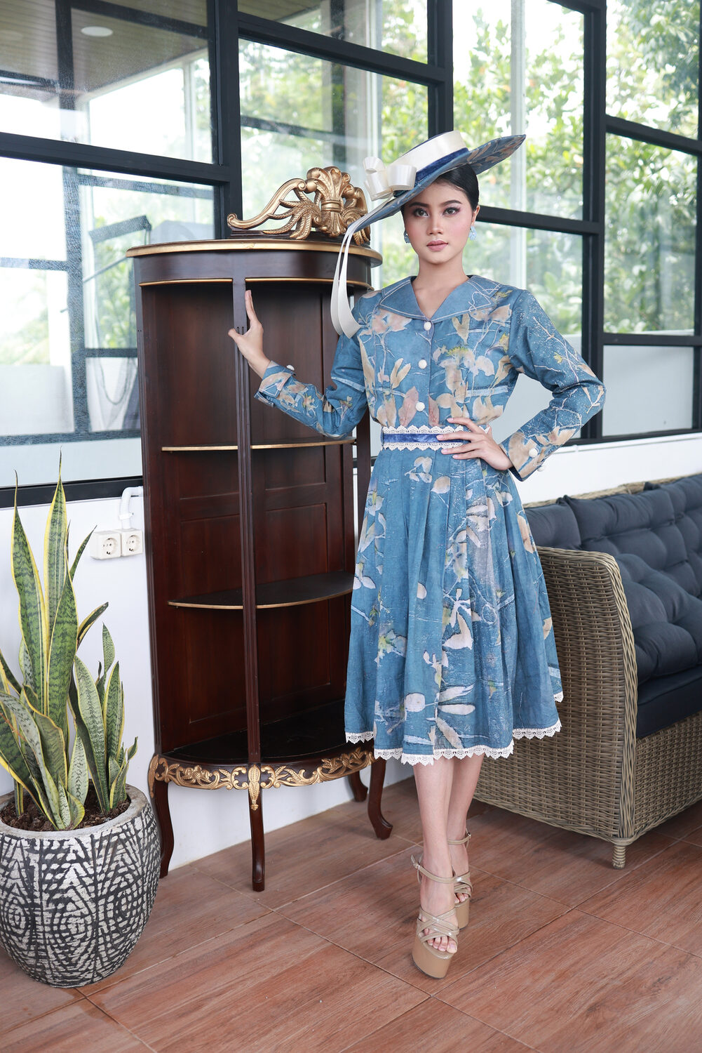Model in a blue eco-print dress with a wide-brim hat