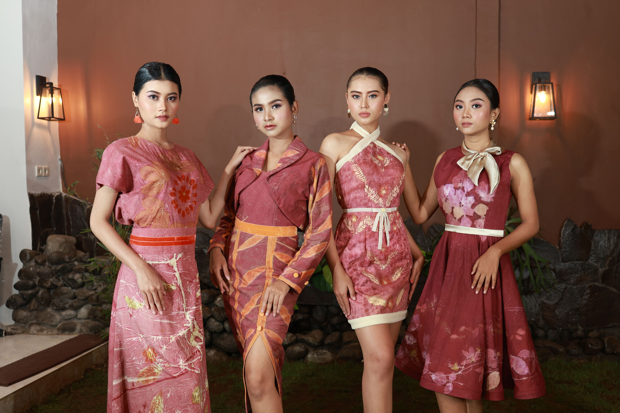 Four models in red, gold and cream eco-print eveningwear