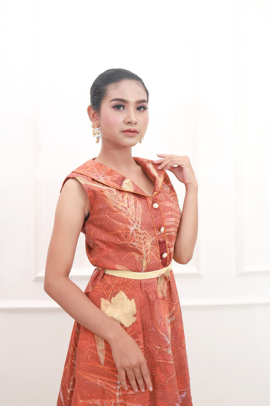 Model in a terracotta eco-print collared dress